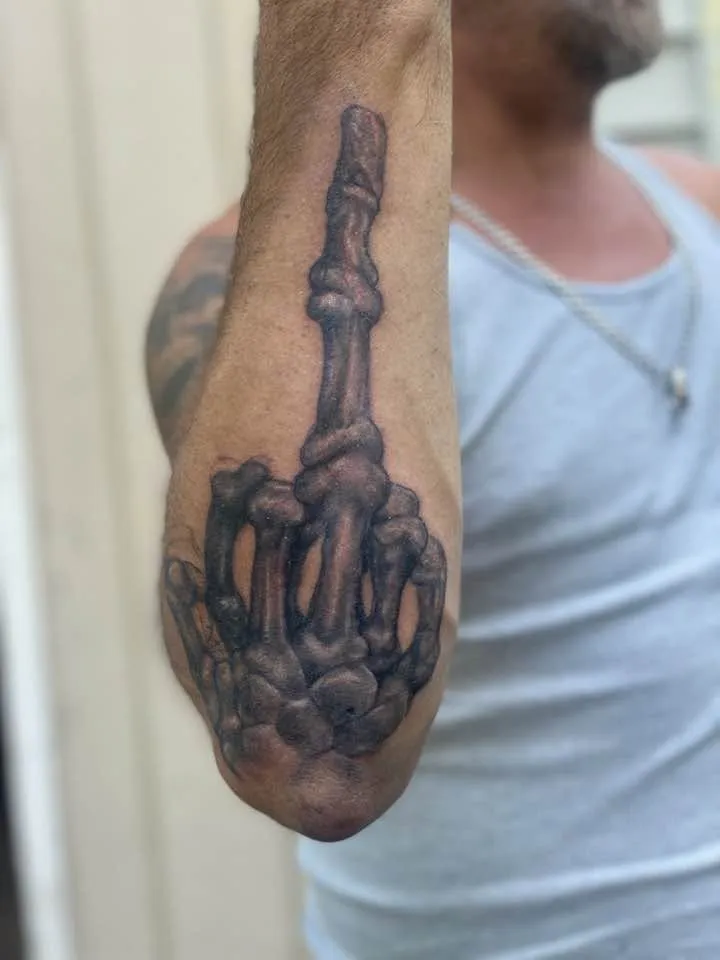 Skeletal hand middle finger, forearm, black & gray